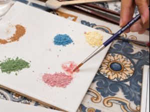 Mixing ceramic paint colours during an Azulejo tile painting workshop in Goa